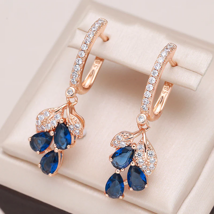Boucles d'oreilles pendantes avec des cristaux bleus | Or